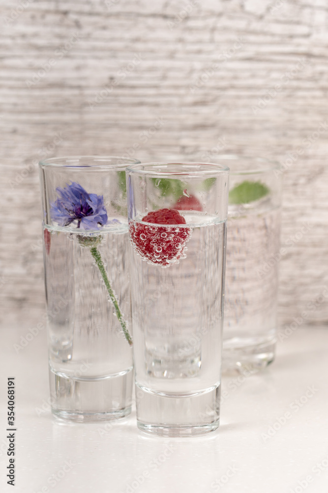 strong alcohol drink with mint and raspberry in high glass strong alcohol drink with mint and raspberry in high glass