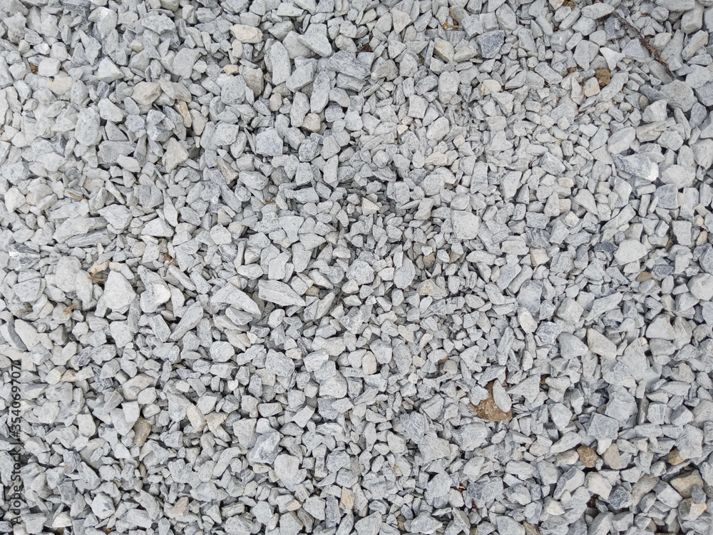 Grey ground stone rubble background of many small stones Grey ground stone rubble background of many small stones