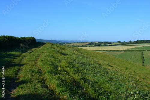 View along Donkey Lane track on the top of a hill, looking to farm fields and distant horizon