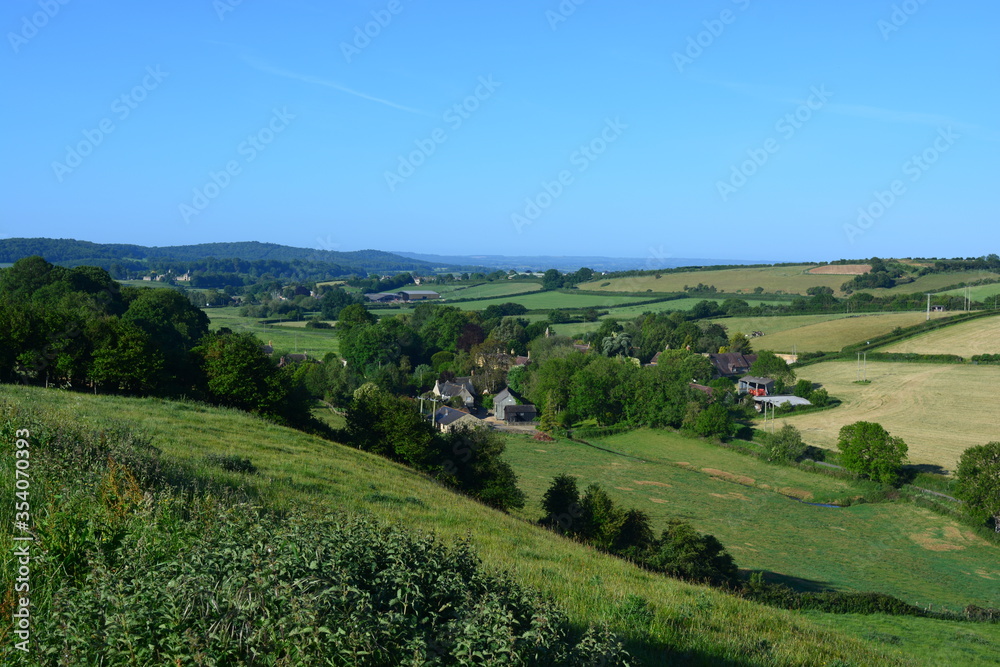 View to Oborne from Donkey Lane track in the summer, over farm fields and village to distant horizon. Dorset, England, UK View to Oborne from Donkey Lane track in the summer, over farm fields and village to distant horizon. Dorset, England, UK