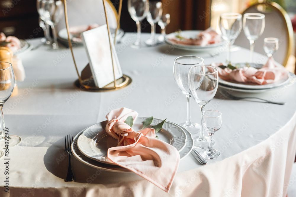 Fototapeta premium Close up festive table setting with empty wine glasses and white plate