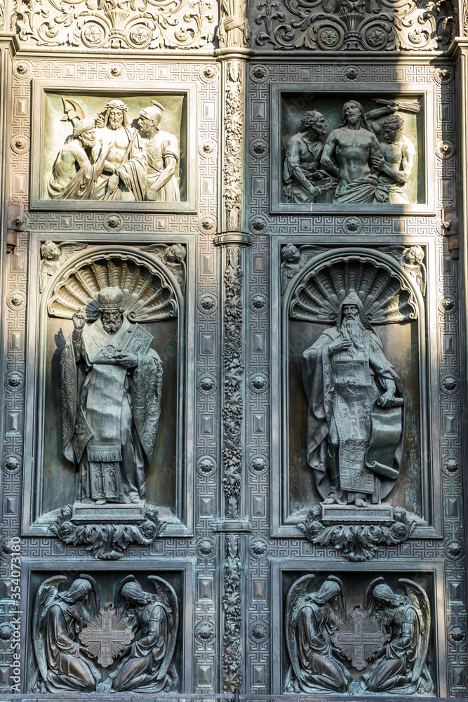Religious statue on the bronze door of Saint Isaac’s Cathedral (or Isaakievskiy Sobor), a monuments of Russian architecture,near Nevsky Avenue and the Hermitage Museum in Saint Petersburg, Russia.