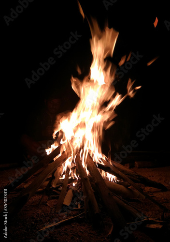 Bonfire in the dark night in the camp.