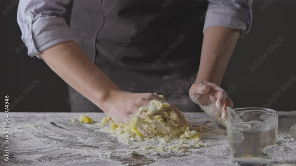 Step by step process of preparation homemade dough. Chef woman's hands knead natural products for pasta on a kitchen table. Slow motion, Full HD video, 240fps, 1080p. Step by step process of preparation homemade dough. Chef woman's hands knead natural products for pasta on a kitchen table. Slow motion, Full HD video, 240fps, 1080p.