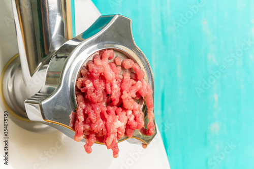 Close-up of cooking minced meat from the meat leaving the grinder. Electric meat grinder.
