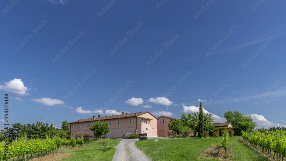View of a high level tourist resort immersed in the Tuscan countryside, on a sunny day with white clouds in the sky, Tuscany, Italy. Time lapse motion View of a high level tourist resort immersed in the Tuscan countryside, on a sunny day with white clouds in the sky, Tuscany, Italy. Time lapse motion