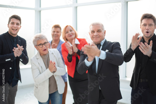 Group of joyful excited business people having fun in office