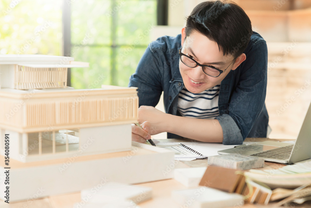 smart smile asian architect interior designer working house design project with home mockup and blueprint paper and material chart sample with enthusiasm focus and confident with garden background smart smile asian architect interior designer working house design project with home mockup and blueprint paper and material chart sample with enthusiasm focus and confident with garden background