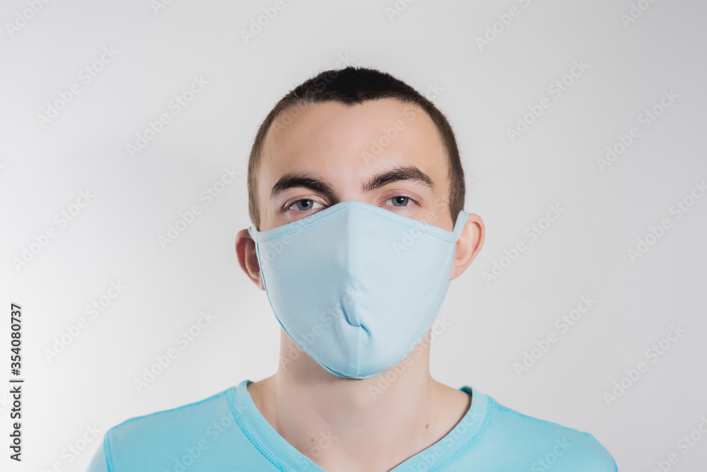 a man in a medical mask from kovid19 blue on a white background a man in a medical mask from kovid19 blue on a white background