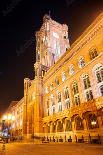 Neo-Renaissance Red Town Hall with the clock tower in the night in the city of Berlin.