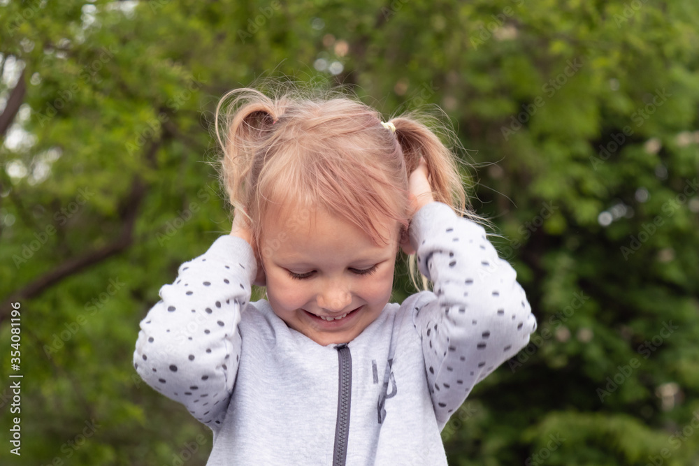 Little funny girl covered her ears with her hands doesn't want to listen. Little funny girl covered her ears with her hands doesn't want to listen.