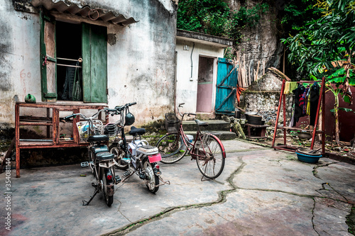 Bicycles standing in front of the old Vietnamese house