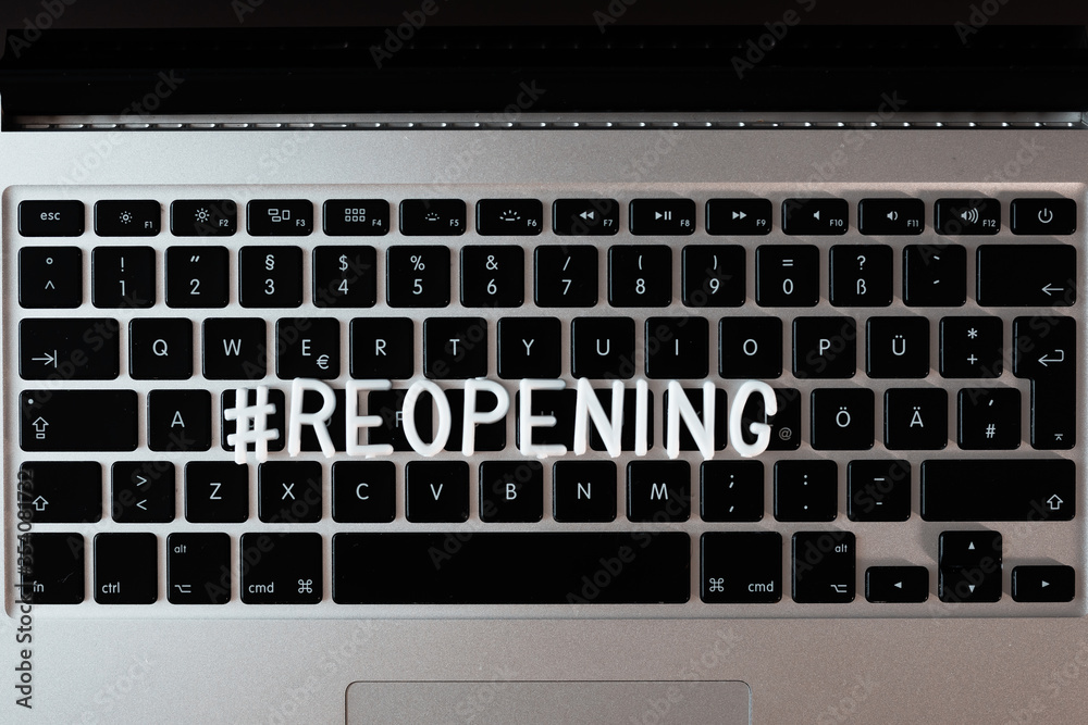 # Reopening text on the notebook keyboard . Business concept. Service, restaurant, shop and cafe re-opening. Reopening of the place after the quarantine due to covid-19. We're open on black background # Reopening text on the notebook keyboard . Business concept. Service, restaurant, shop and cafe re-opening. Reopening of the place after the quarantine due to covid-19. We're open on black background