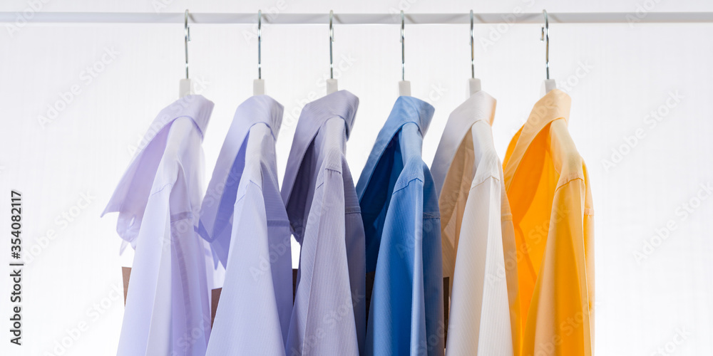 Men's dress shirts, Clothes on hangers on white background Men's dress shirts, Clothes on hangers on white background