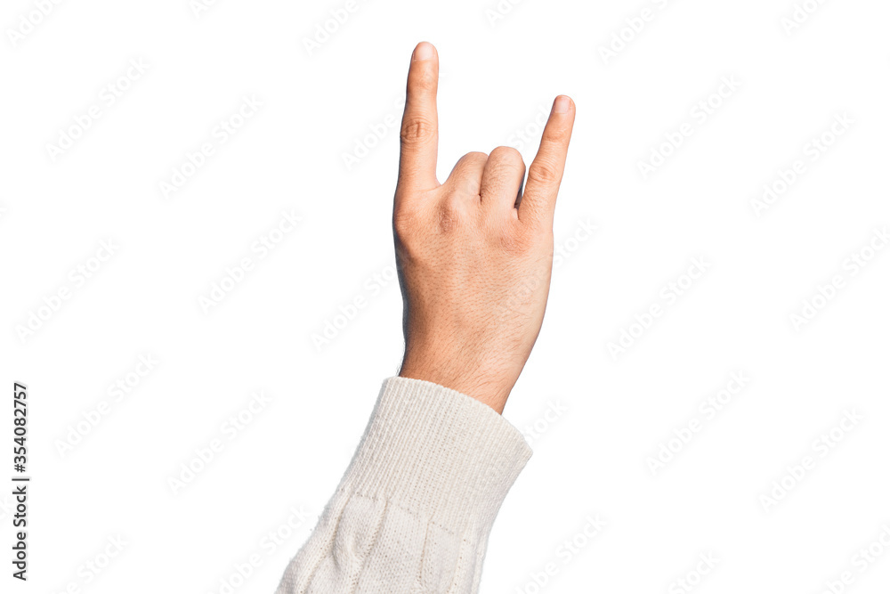 Hand of caucasian young man showing fingers over isolated white background gesturing rock and roll symbol, showing obscene horns gesture Hand of caucasian young man showing fingers over isolated white background gesturing rock and roll symbol, showing obscene horns gesture