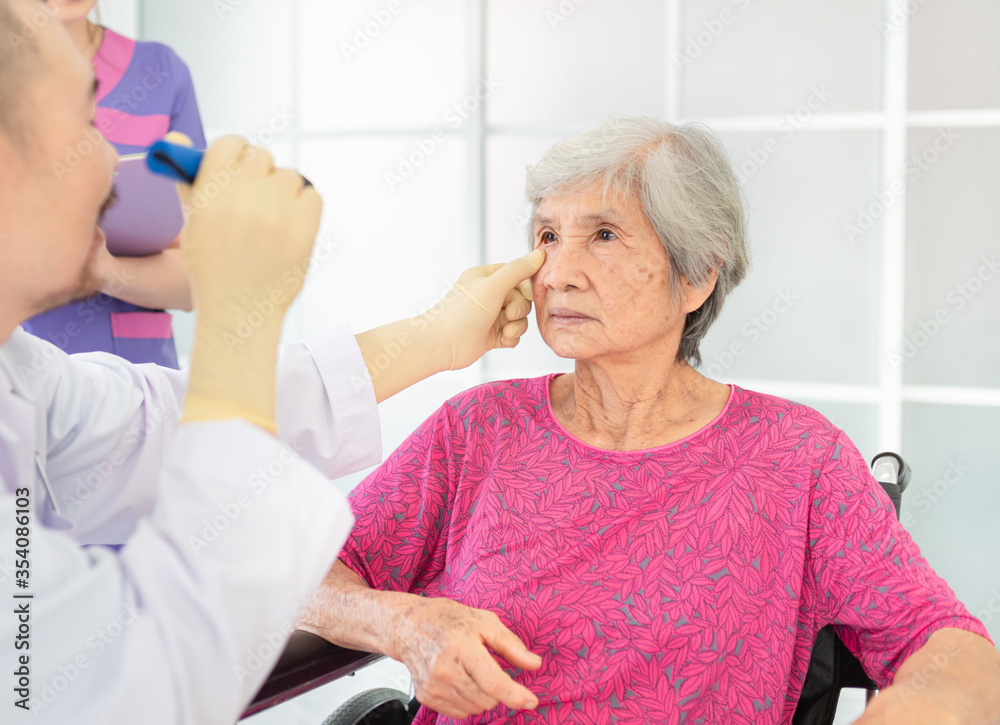 doctor use flashlight screening eyes of old asian patient, vision and cataract screening, elderly healthcare check up in hospital doctor use flashlight screening eyes of old asian patient, vision and cataract screening, elderly healthcare check up in hospital