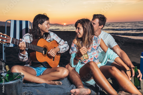Group of friends enjoy on the beach © Mediteraneo