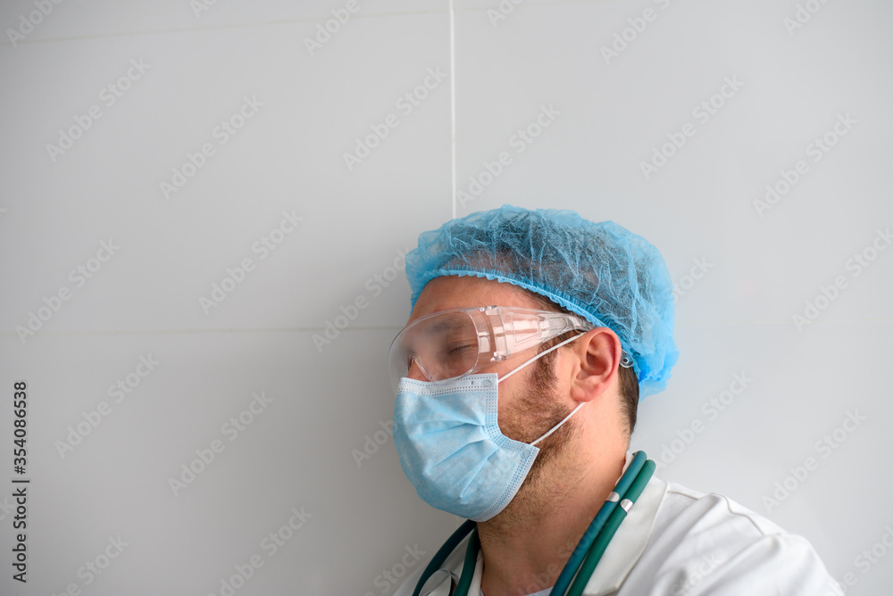 Exhausted doctor with closed eyes in face mask Exhausted doctor with closed eyes in face mask