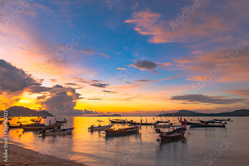 beautiful sunrise above fishing boats on Rawai beach, Phuket,Thailand.. © Narong Niemhom