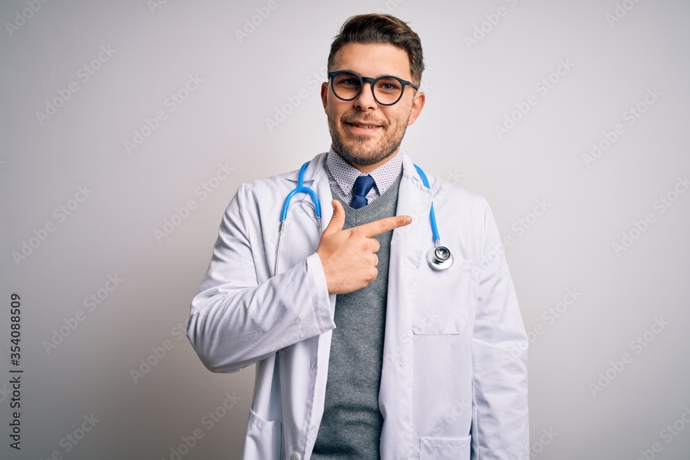 Young doctor man with blue eyes wearing medical coat and stethoscope over isolated background cheerful with a smile on face pointing with hand and finger up to the side with happy and natural Young doctor man with blue eyes wearing medical coat and stethoscope over isolated background cheerful with a smile on face pointing with hand and finger up to the side with happy and natural