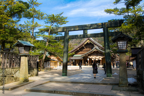 Kane-no-Torii (Bronze Torii) in Izumo Taisha Shrine with two lamps on each side with the kanji characters 