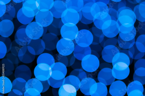 Abstract blue bokeh texture on black background