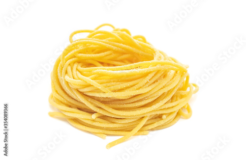 Fresh spaghetti pasta rolled in a nest isolated on a white background