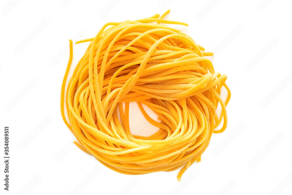 Fresh colored spaghetti pasta with carrots rolled in a nest isolated on a white background