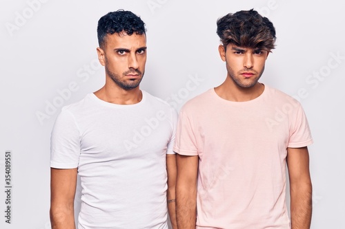 Young gay couple wearing casual clothes skeptic and nervous, frowning upset because of problem. negative person.