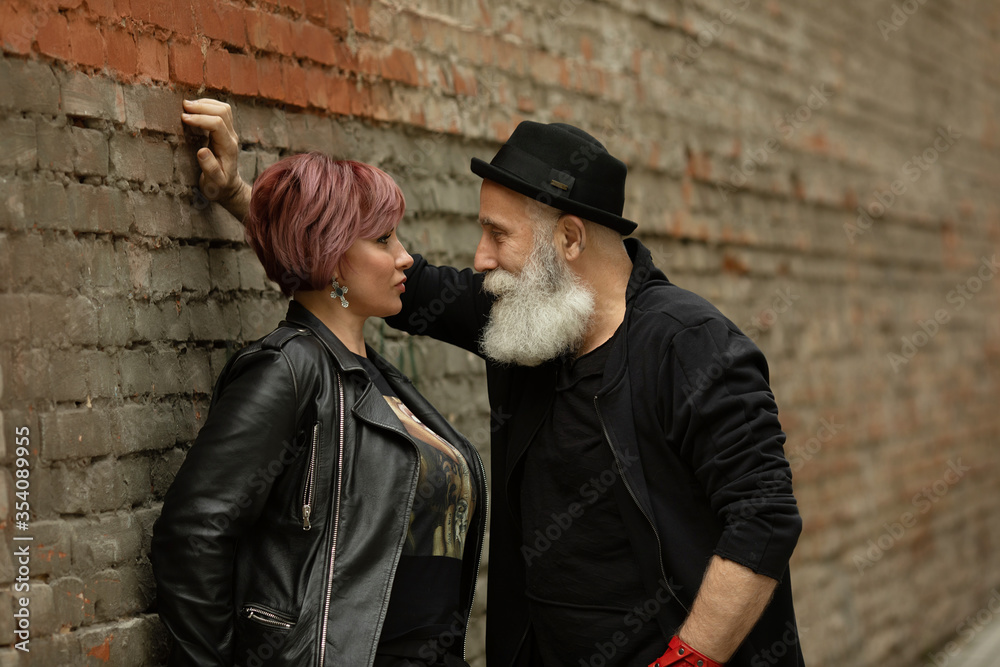 Bearded Senior man and woman wearing leather jackets. Happy couple of retirees in biker clothes.