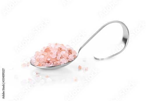 Pink Himalayan salt on a spoon isolated on white background.