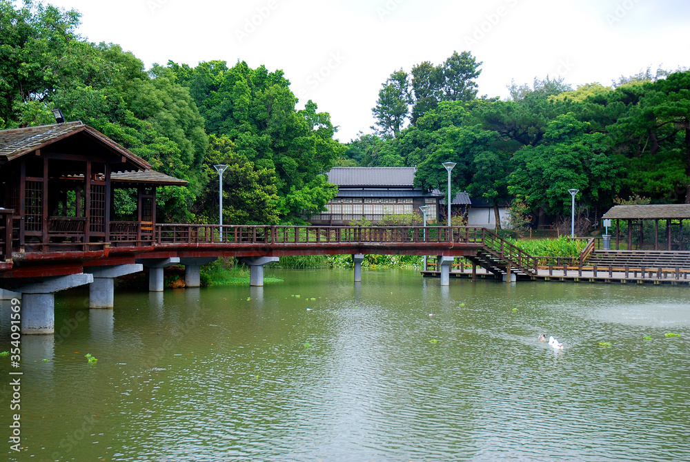 Hsingchu, Taiwan park area with pond and traditonal architecture buildings