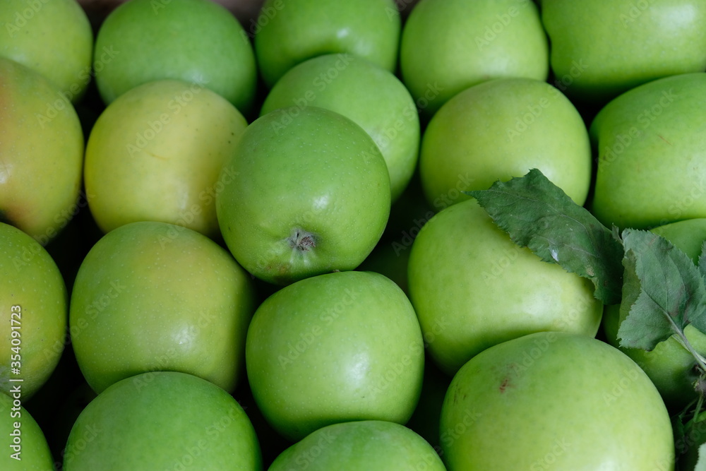 Lots of beautiful green apples on the market square, tasty and juicy, fresh and ripe fruit. Lots of beautiful green apples on the market square, tasty and juicy, fresh and ripe fruit.