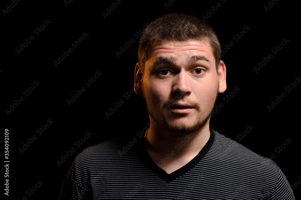 Surprised man on a dark background Surprised man on a dark background