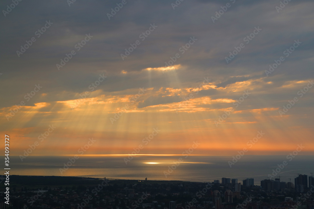 Breathtaking Sunrise Sky with the God Ray over the Sea and the City