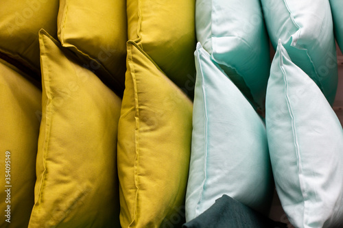 a set of multi-colored pillows in limbo in a supermarket.
