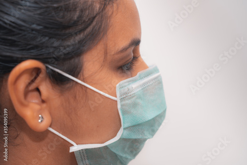 Young woman wearing surgical mask during the pandemic situation.