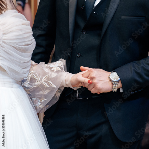 bride and groom hold hands