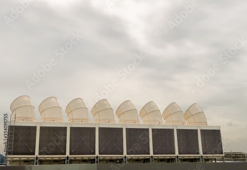 cooling tower on the top roof of building in the afternoon,which have the blue sky background.