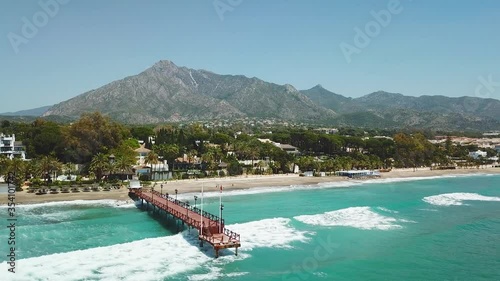 Beautiful and unique cinematic aerial view of luxury and exclusive area of Marbella, golden mile beach, Puente Romano Bridge.Luxury Clubs, Urbanisation in the most expensive area of Marbella. Forward