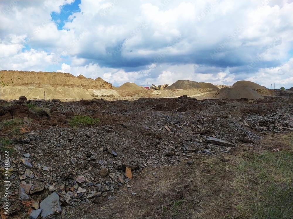 a large pile of sand and soil on the site of the quarry