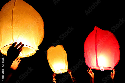 Leaving lanterns in the Sky through the darkness