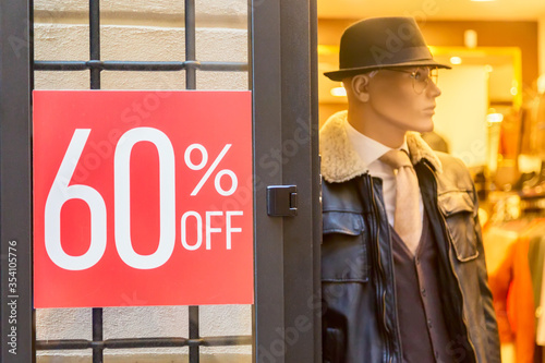 Photography Male mannequin near sign with discount inscription SALE 60 in a clothing store