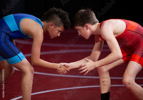 Two wrestlers competing on the mat