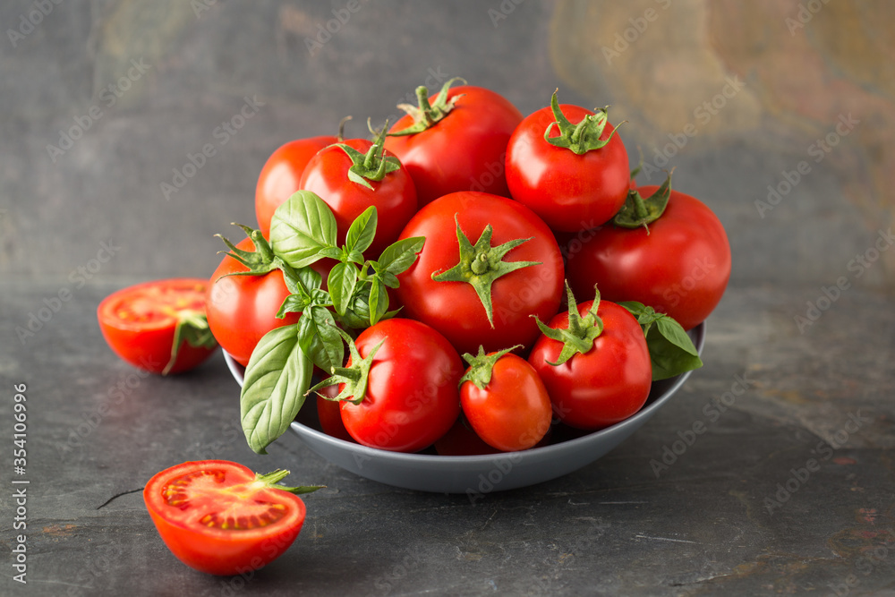 Ripe organic tomatoes and basil in the bowl Ripe organic tomatoes and basil in the bowl