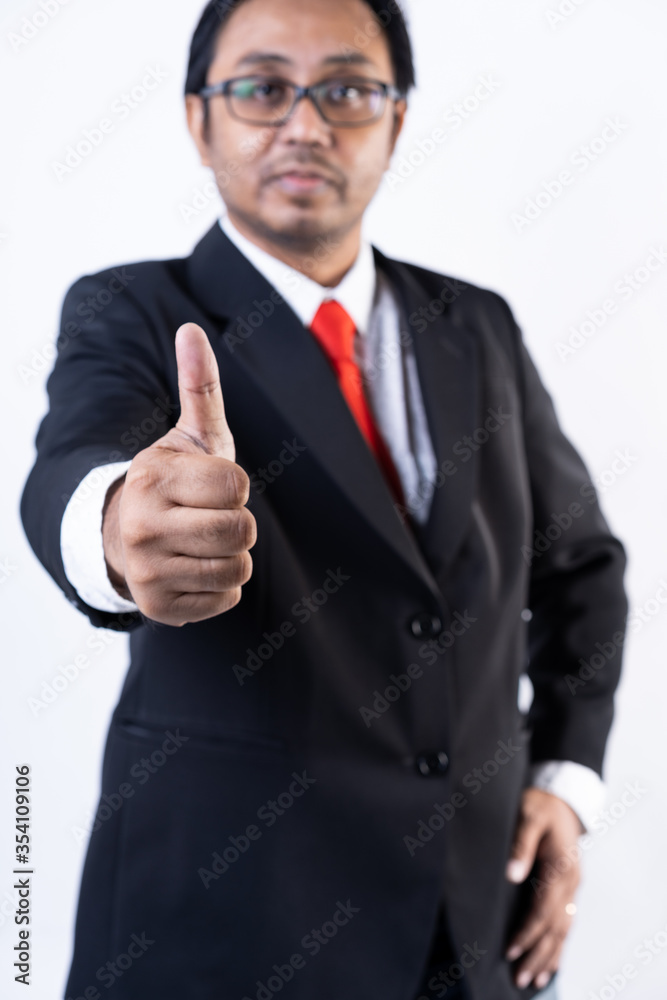 Closed up shot of a man in suit showing thumbs up Closed up shot of a man in suit showing thumbs up