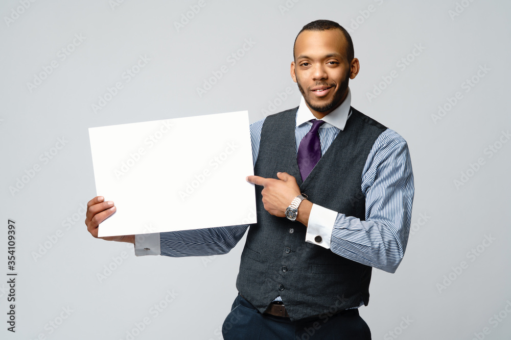 professional african-american business man - presenting holding blank sign professional african-american business man - presenting holding blank sign