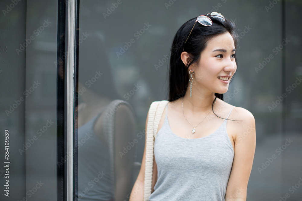 woman smiling in urban background. girl wearing casual clothes.
