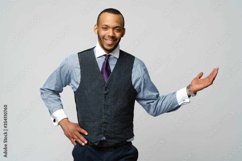 professional african-american business man - presenting points a hand at copy space professional african-american business man - presenting points a hand at copy space