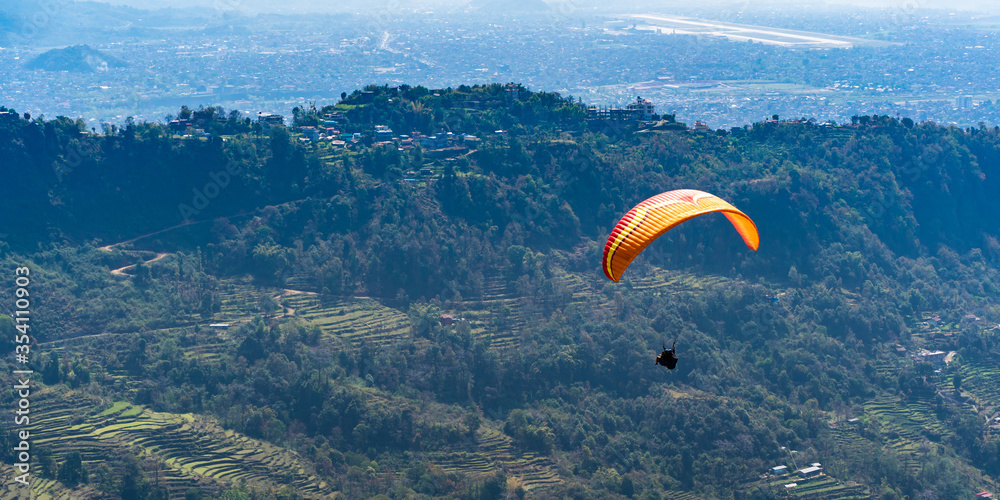 Paragliding in Nepal. Paraglider on the background Pokhara city and surrounding villages. Stock photo. Paragliding in Nepal. Paraglider on the background Pokhara city and surrounding villages. Stock photo.